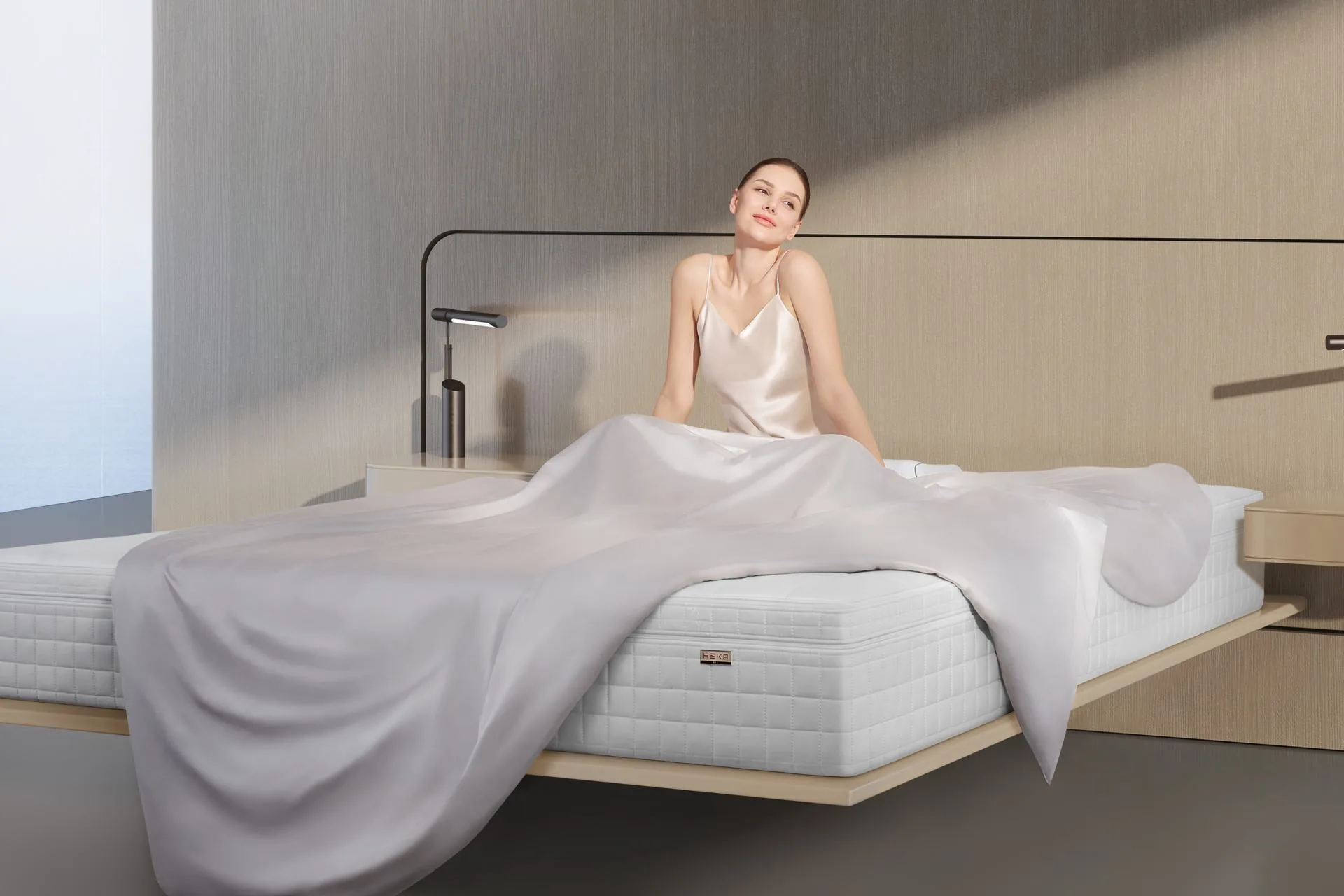 Người phụ nữ thức dậy nhẹ nhàng trên giường HEKA trong ánh sáng buổi sớm